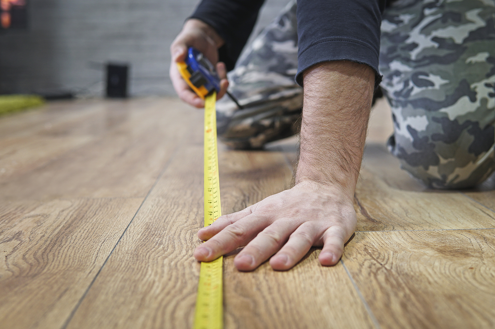 cvt direct - male hands measuring wood flooring